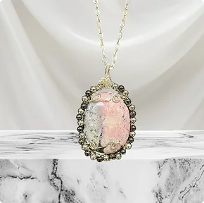 Rhodonite Palm Stone wrapped in Silver Plated Silver accented with Metallic Beads