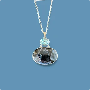 Pietersite Necklace accented with Blue Topaz. 18″ SS Chain